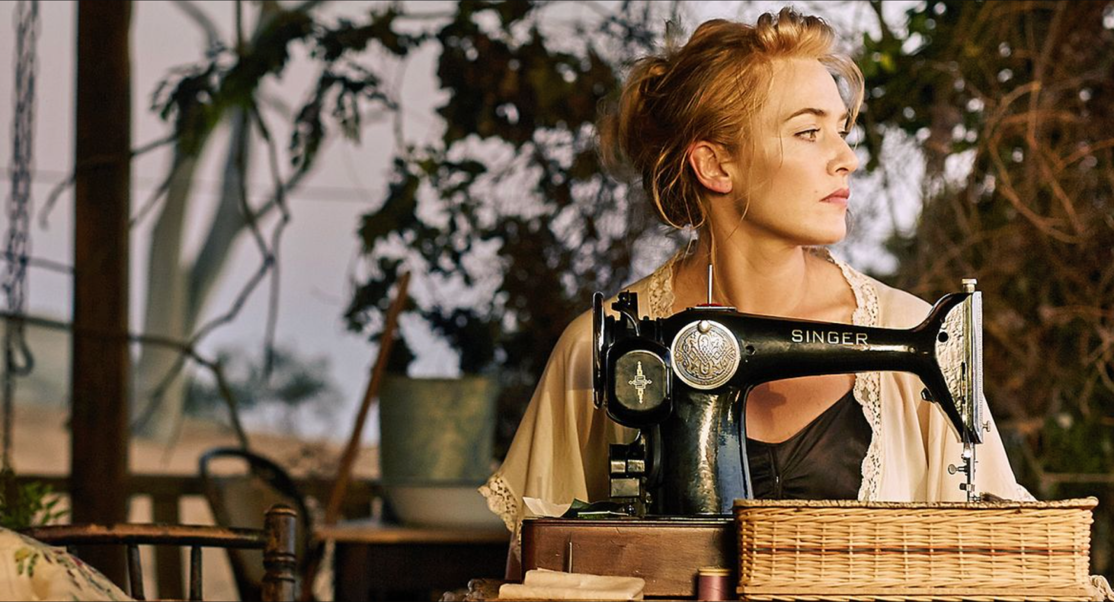 A still image of Tilly Dunnage at the Singer sewing machine from the Australian film, The Dressmaker.
